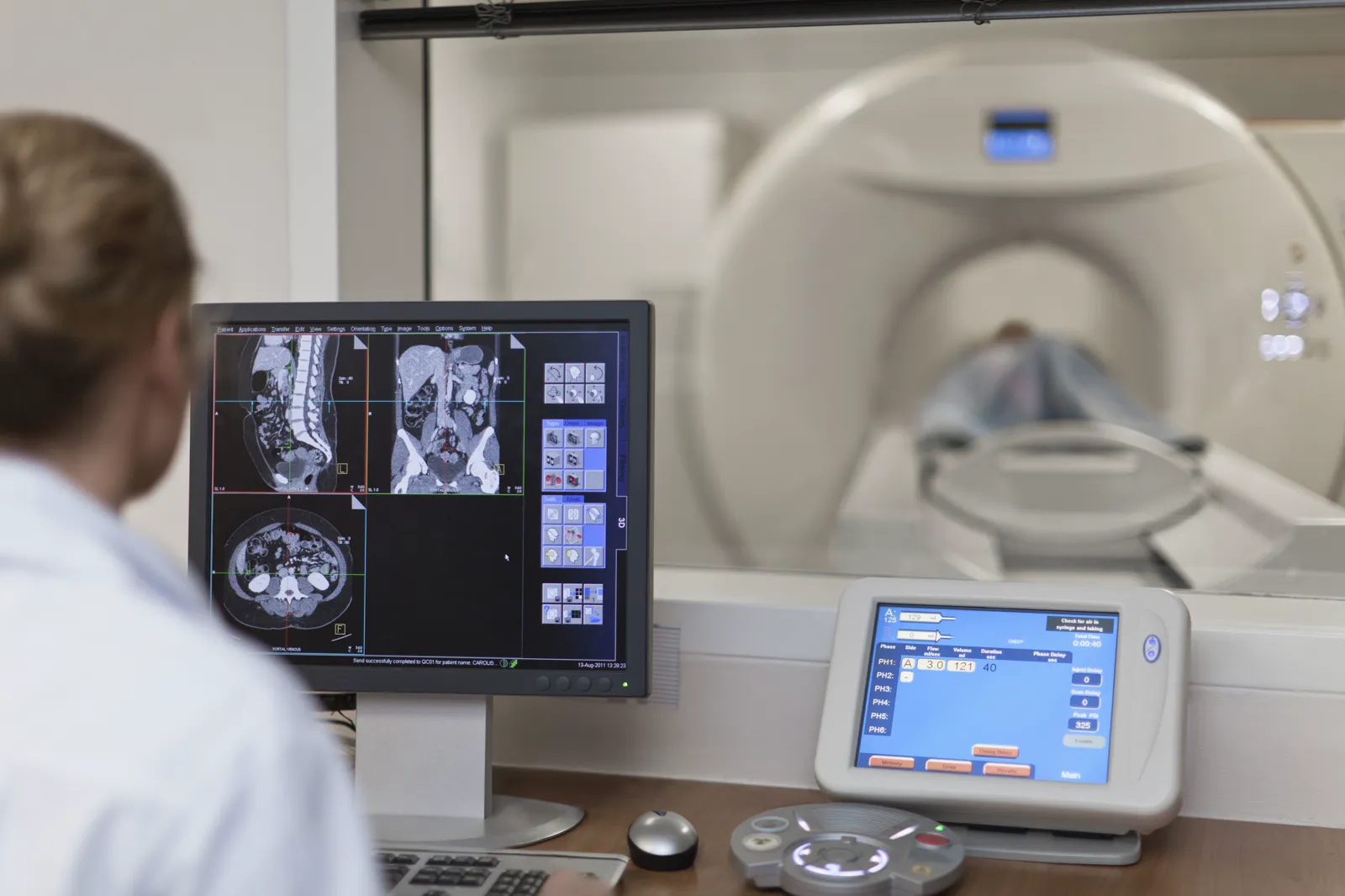 Radiographer monitoring medical imaging