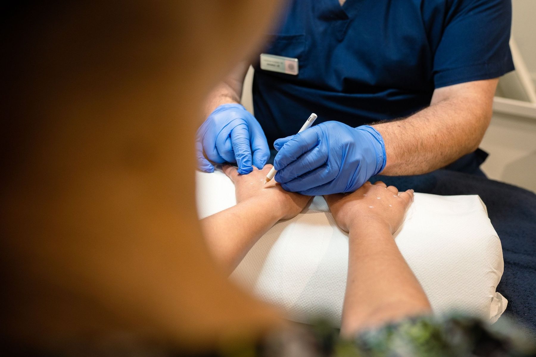 Dr Lorenzo performing a hand rejuvenation treatment